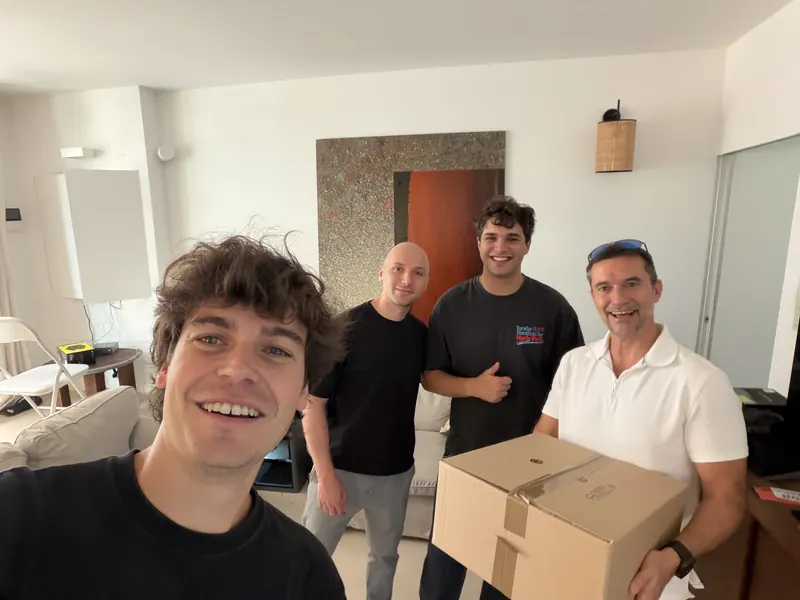 The team together in the office, holding a box