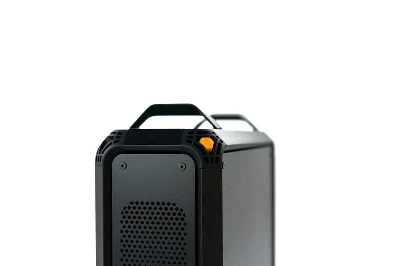 Close-up of the Lucebox chassis top, carry handles and orange button