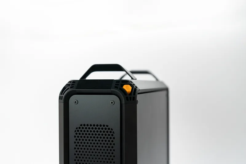 Close-up of the Lucebox chassis top, carry handles and orange button
