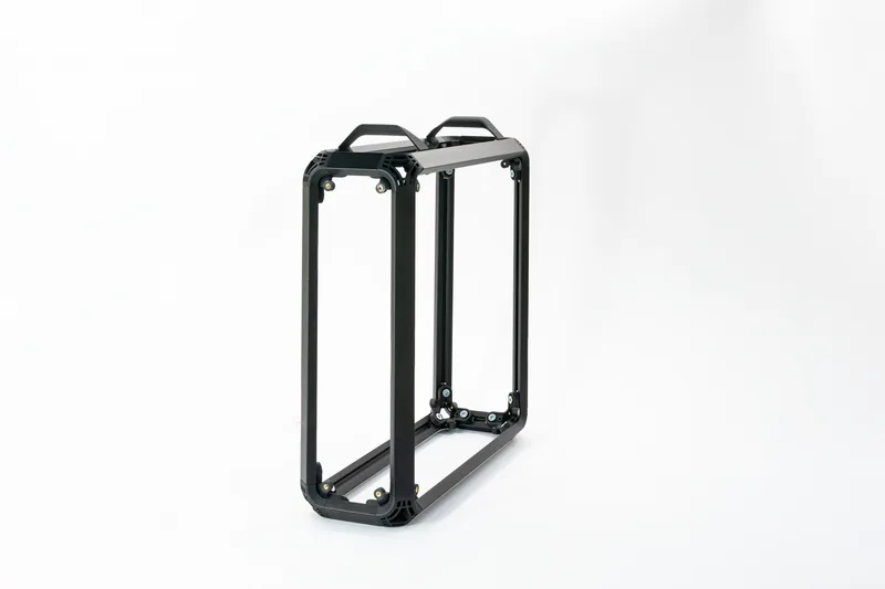 The bare extruded aluminium frame of the chassis, anodized black, before the panels go on
